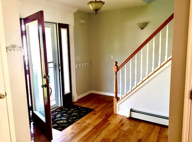 entryway with a baseboard radiator and wood-type flooring