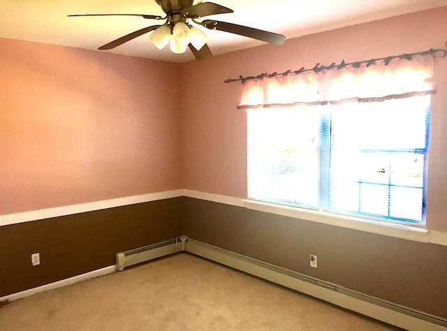 carpeted empty room with baseboard heating and ceiling fan