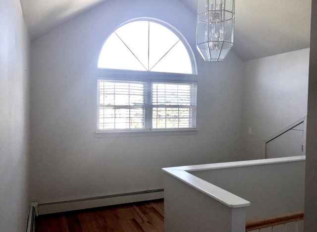 interior space with lofted ceiling, dark hardwood / wood-style floors, and baseboard heating