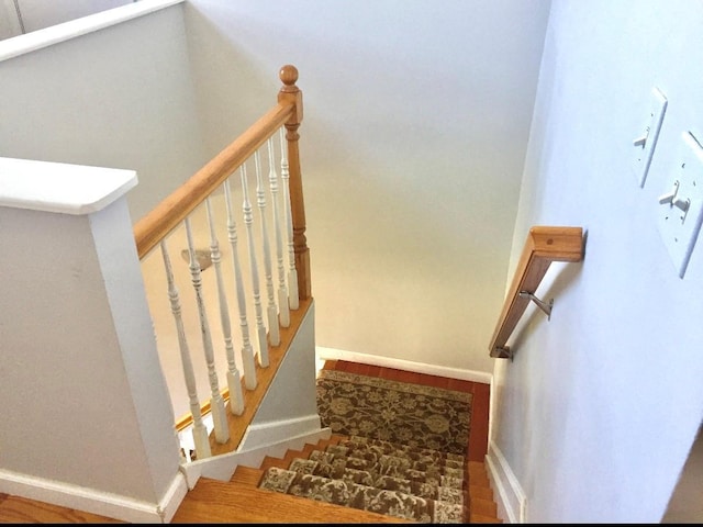 stairway featuring wood-type flooring