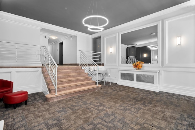 staircase featuring crown molding and carpet flooring