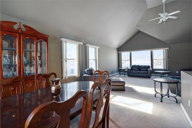 carpeted dining area featuring vaulted ceiling and ceiling fan