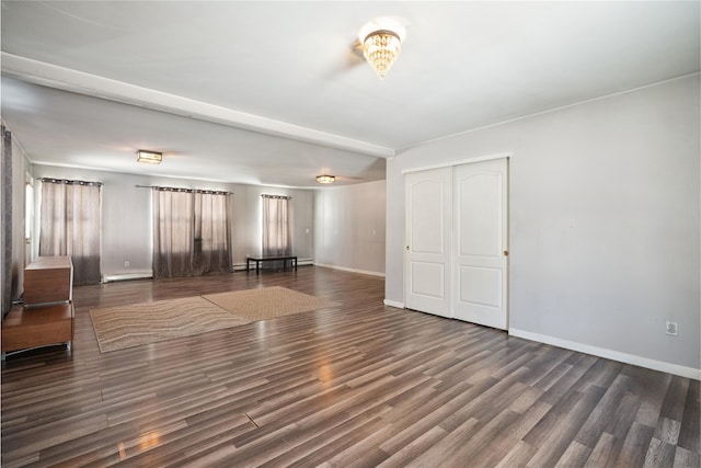 unfurnished living room with dark wood-type flooring