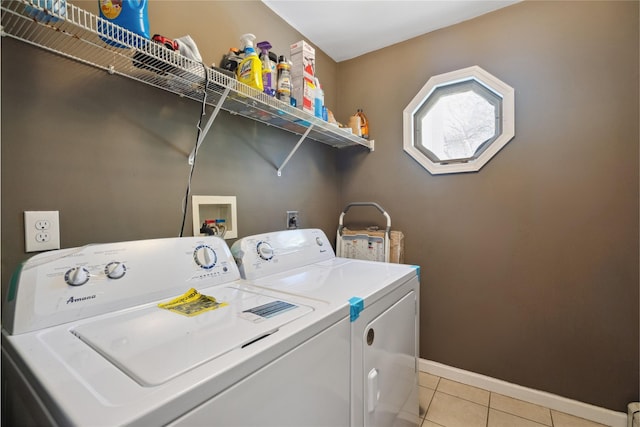 clothes washing area featuring independent washer and dryer and light tile patterned floors