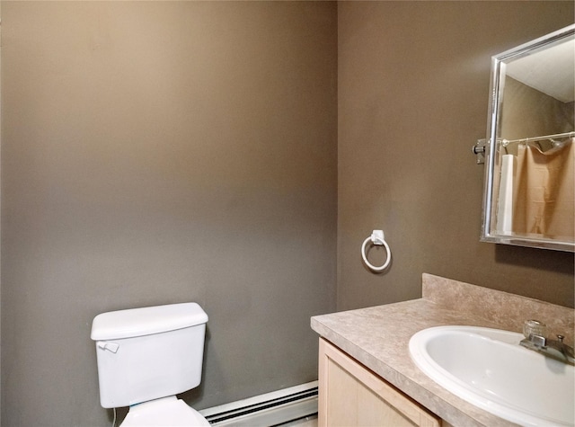 bathroom with vanity, baseboard heating, and toilet