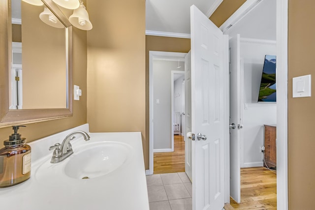 bathroom featuring tile patterned floors, ornamental molding, and vanity