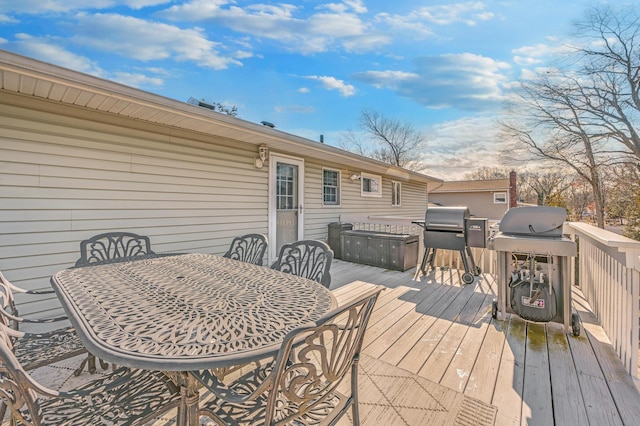 wooden deck with a grill