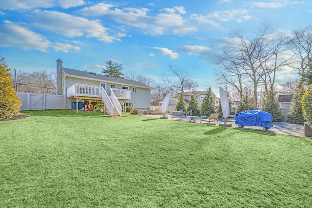 view of yard with a swimming pool side deck and a patio area