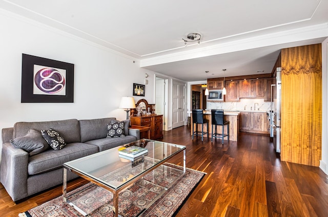 living room featuring dark wood-type flooring and ornamental molding