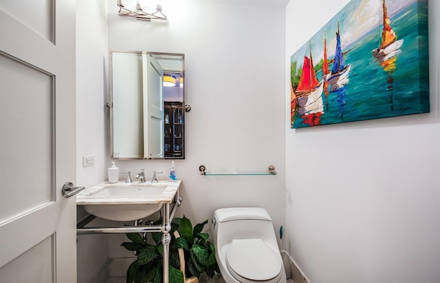 bathroom featuring sink and toilet