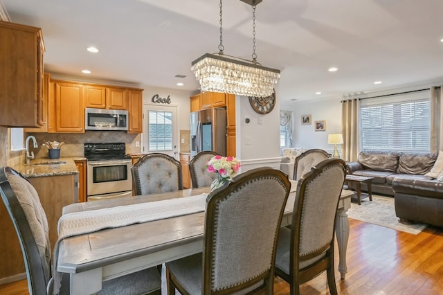 dining area featuring sink and light wood-type flooring