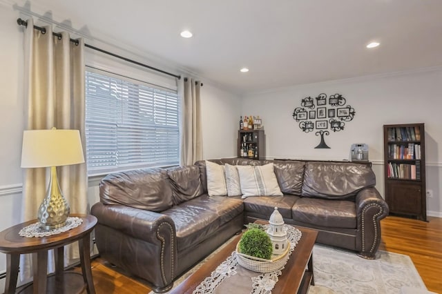 living room featuring hardwood / wood-style floors and crown molding