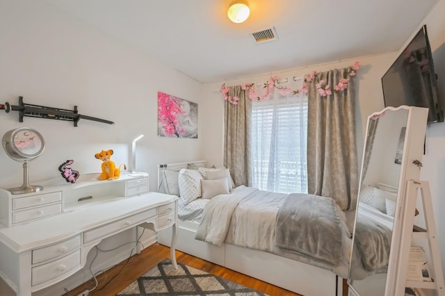 bedroom with hardwood / wood-style floors