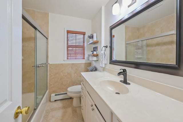 full bathroom featuring enclosed tub / shower combo, tile walls, vanity, a baseboard radiator, and toilet