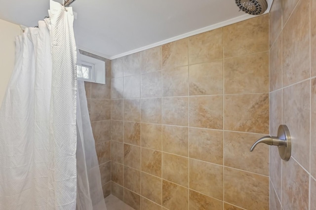 bathroom featuring crown molding and walk in shower