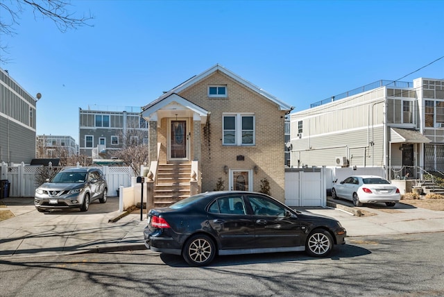 view of front of house with fence and brick siding