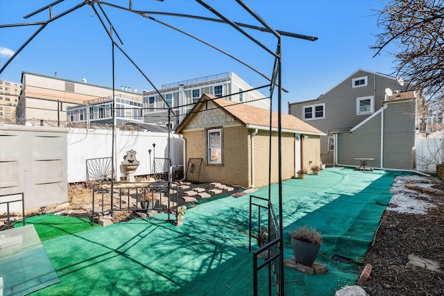 view of swimming pool featuring a patio, an outbuilding, and a fenced backyard