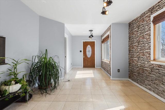 foyer with light tile patterned floors and baseboards