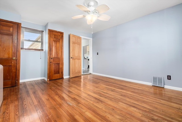 unfurnished bedroom featuring baseboards, visible vents, ceiling fan, hardwood / wood-style flooring, and a closet