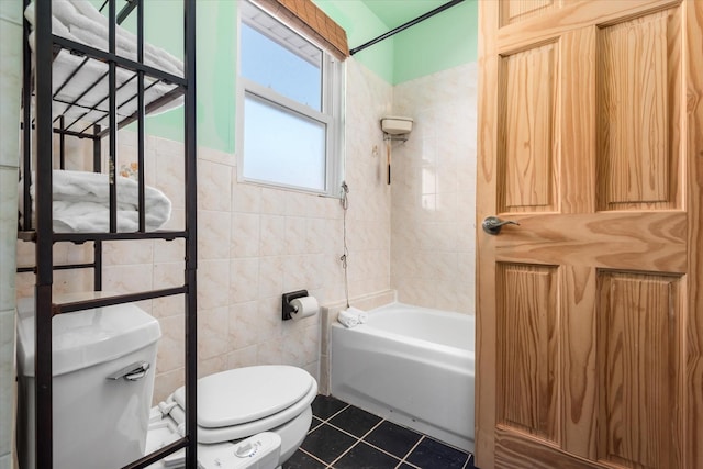 bathroom featuring tile patterned floors, toilet, tile walls, and  shower combination