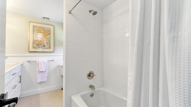 bathroom with shower / tub combo, vanity, and tile patterned flooring