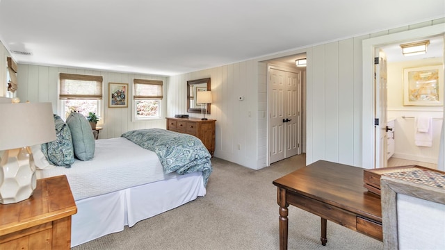 carpeted bedroom featuring connected bathroom