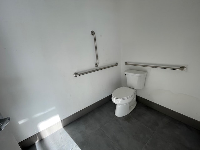 bathroom featuring toilet and tile patterned flooring