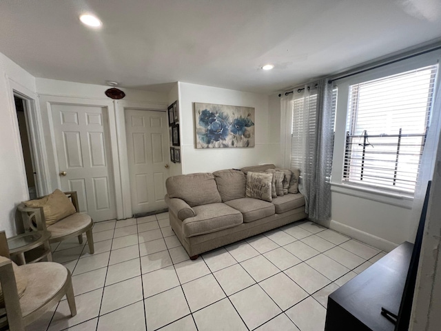 living area featuring baseboards, recessed lighting, and light tile patterned floors