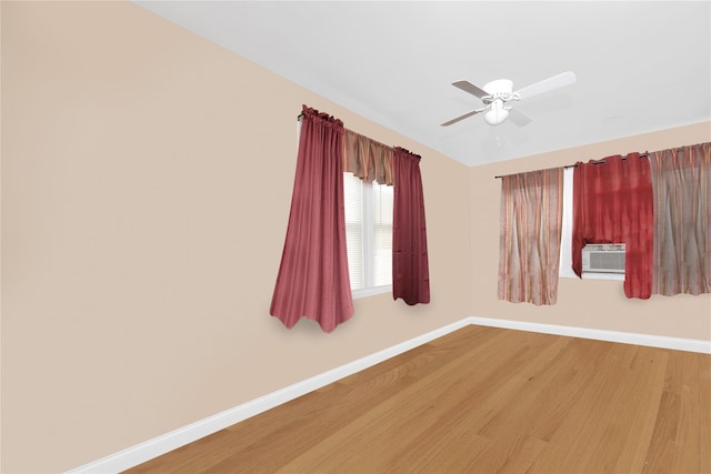 unfurnished room featuring cooling unit, hardwood / wood-style floors, lofted ceiling, and ceiling fan