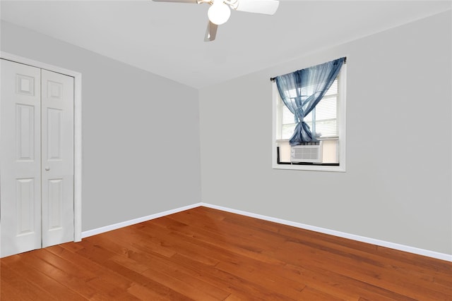 unfurnished bedroom with hardwood / wood-style flooring, ceiling fan, and a closet