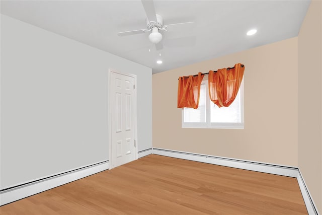 unfurnished room with a baseboard radiator, hardwood / wood-style floors, and ceiling fan