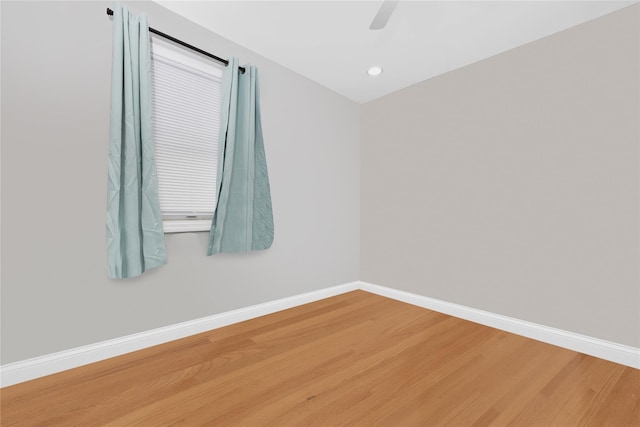 spare room with hardwood / wood-style floors and ceiling fan