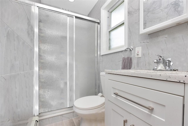 bathroom featuring vanity, a shower with shower door, toilet, and baseboard heating