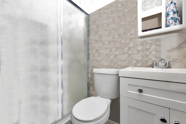 bathroom with walk in shower, vanity, and toilet