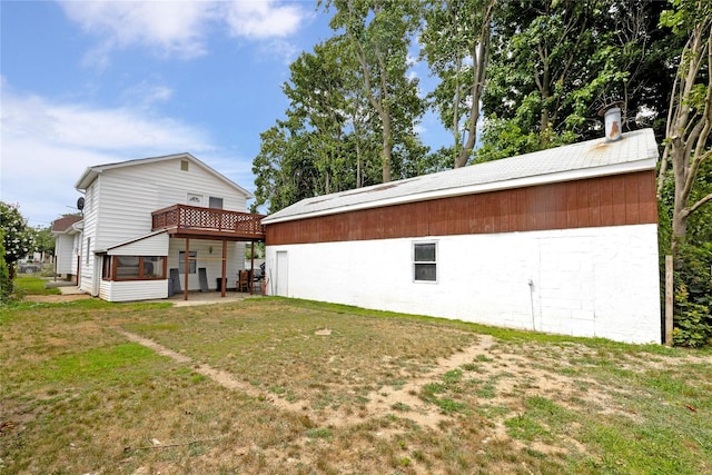 rear view of property featuring a yard