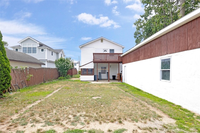 rear view of property with a yard