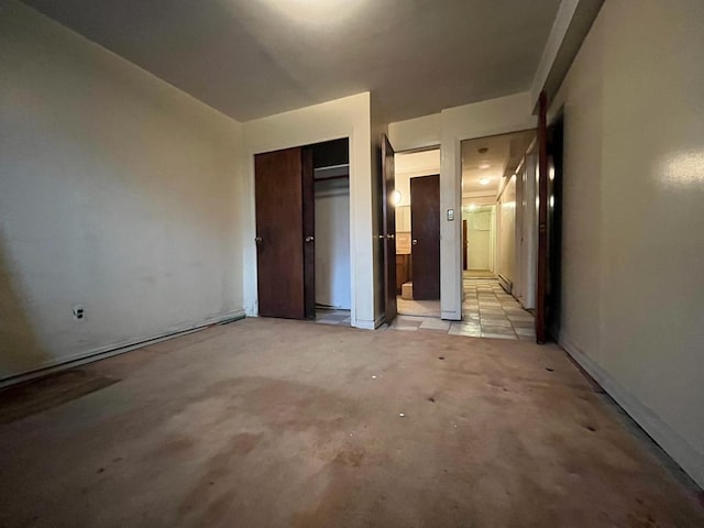 unfurnished bedroom featuring connected bathroom and a closet