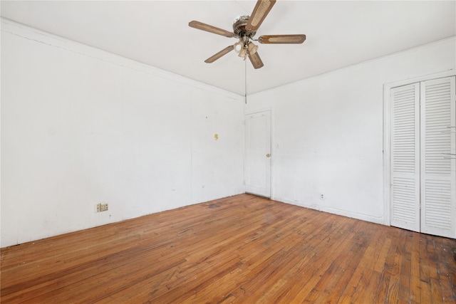 unfurnished room with ceiling fan and dark hardwood / wood-style flooring