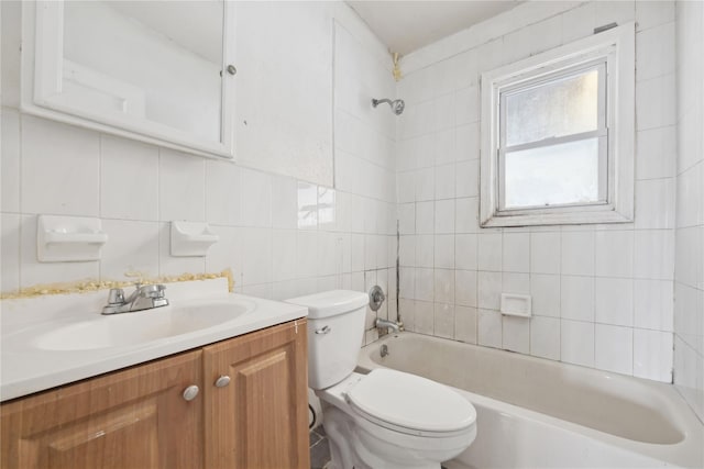 full bathroom featuring tile walls, tiled shower / bath combo, vanity, tasteful backsplash, and toilet