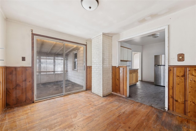 interior space featuring light wood-type flooring and wood walls