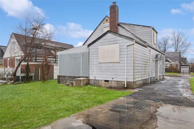 view of side of property with a lawn