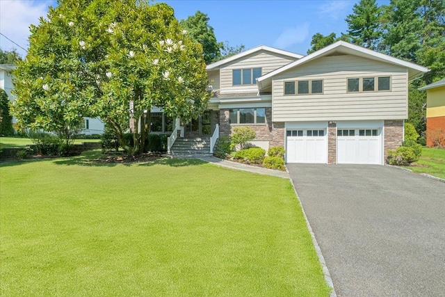 view of front of home featuring a garage, stone siding, a front lawn, and aphalt driveway