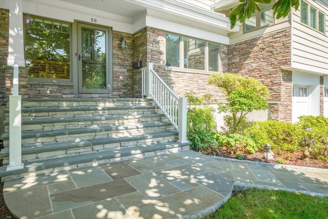 view of exterior entry featuring stone siding