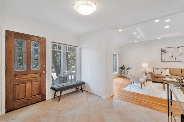 entryway featuring baseboards, light tile patterned flooring, and recessed lighting