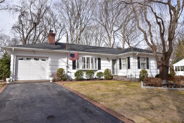 ranch-style home with a garage and a front yard