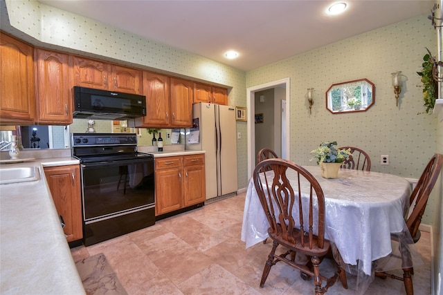 kitchen featuring sink and black appliances