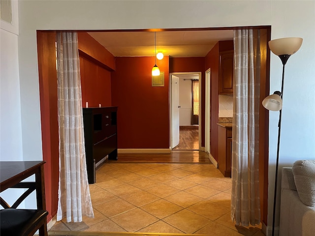 corridor featuring light tile patterned floors