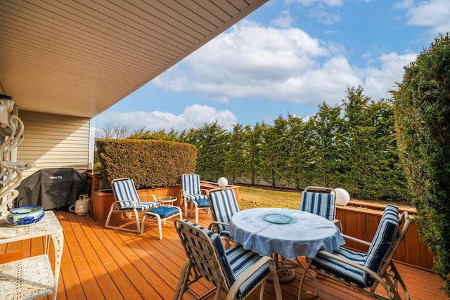 wooden terrace with outdoor dining area