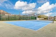 view of tennis court with fence