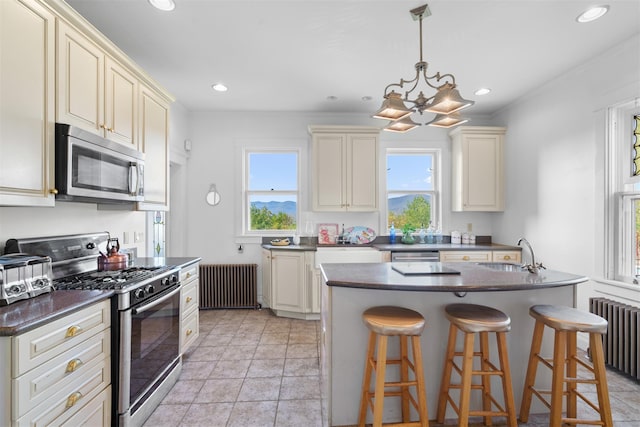 169 Baker Rd, West Hurley, NY 12491 - kitchen featuring radiator, appliances with stainless steel finishes, a sink, cream cabinets, and recessed lighting